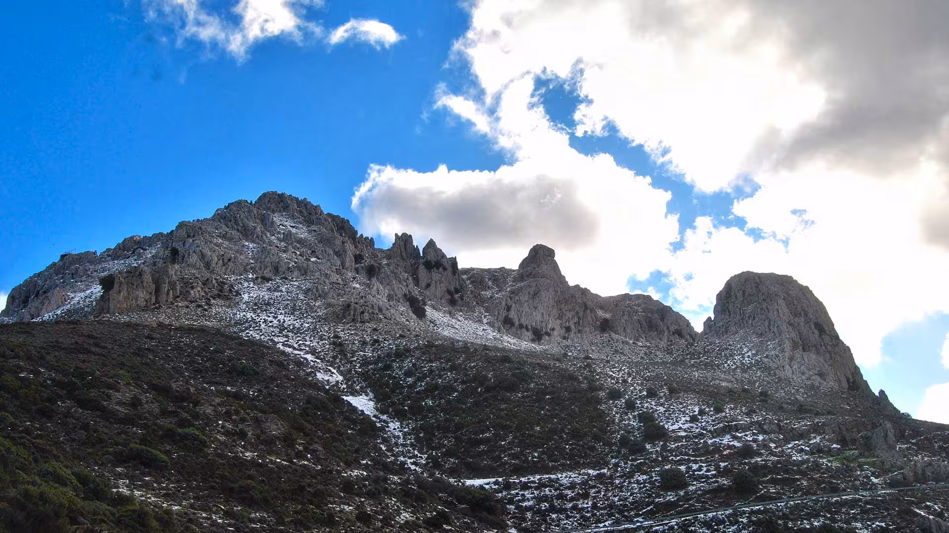 Dramatic rocky peaks under a vibrant sky at Lula Montalbo, perfect for adventurous hiking enthusiasts.