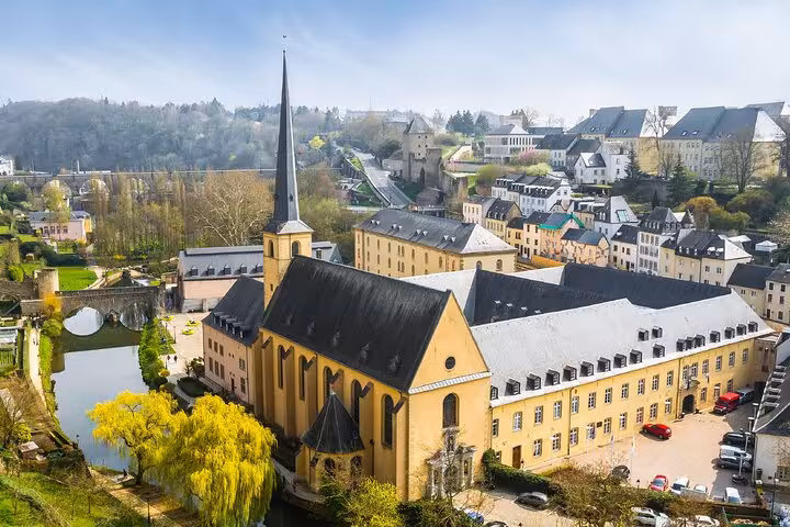 Aerial view of Neumünster Abbey and old town Luxembourg City with church spire and Alzette river
