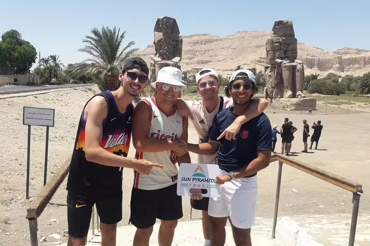 Friends pose at Luxor Colossi of Memnon on 4 days 3 nights Luxor to Abu Simbel short break tour