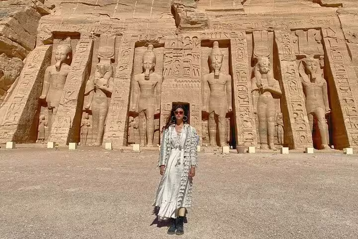 Traveler at Abu Simbel Great Temple statues in Egypt, key stop on the 4 days 3 nights Luxor to Abu Simbel package