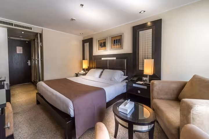 Double cabin interior on Luxor Aswan Nile cruise, cozy bed and seating for 5-day Egypt itinerary