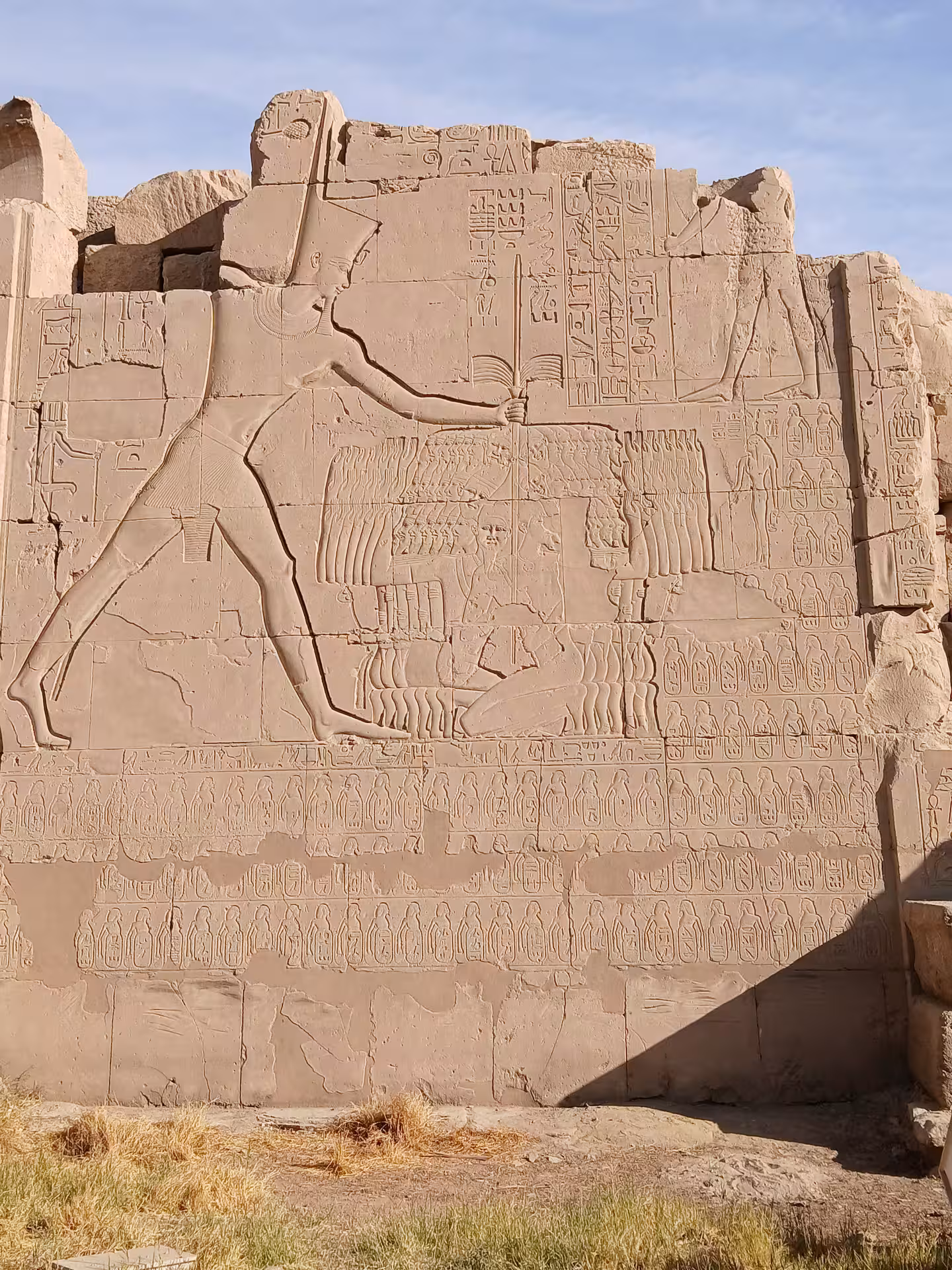 Ancient hieroglyphics and carvings on a temple wall in Egypt, showcasing the rich history of Luxor and Aswan tours.