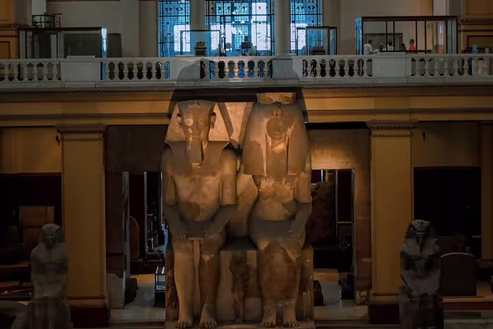 Colossal pharaoh statues inside the Egyptian Museum in Cairo, a highlight after the overnight Luxor to Cairo VIP train
