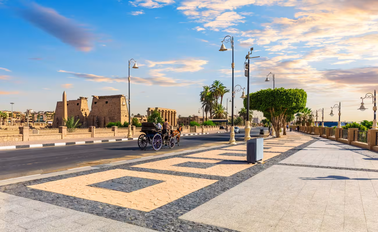 Luxor Corniche with horse carriage near Karnak Temple, scenic moment on an 8-day budget Nile cruise adventure