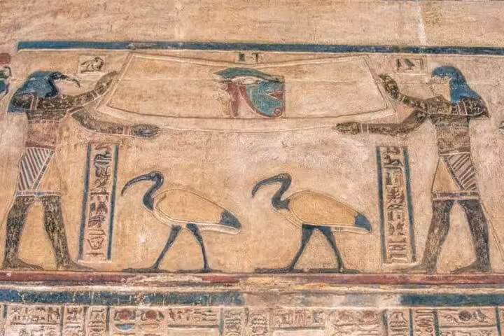 Colorful tomb painting with Horus figures and sacred birds, seen on 2-day private Luxor and Dendera tour from Hurghada