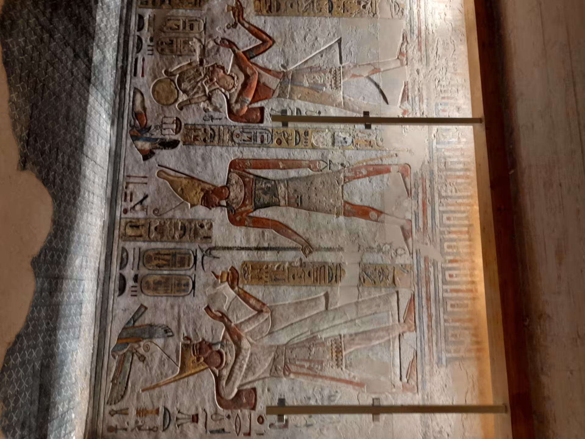 Admire the vibrant frescoes of Egyptian gods in traditional attire, showcasing Luxor's rich historical legacy.