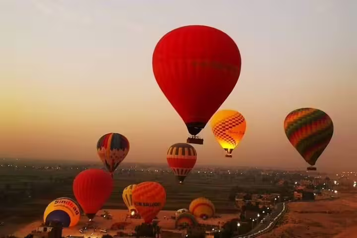 Colorful hot air balloons at dawn over Luxor, Egypt, with Nile Valley views on a sunrise balloon tour