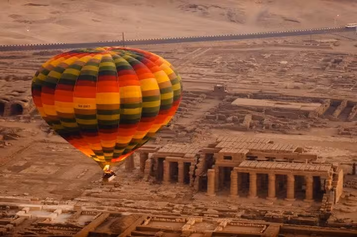 VIP Luxor hot air balloon sunrise flight over ancient temple ruins, with hotel pickup and Nile West Bank views