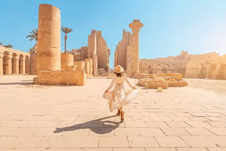 Solo traveler exploring Karnak Temple courtyard in Luxor on a private day tour with flexible itinerary and carriage ride