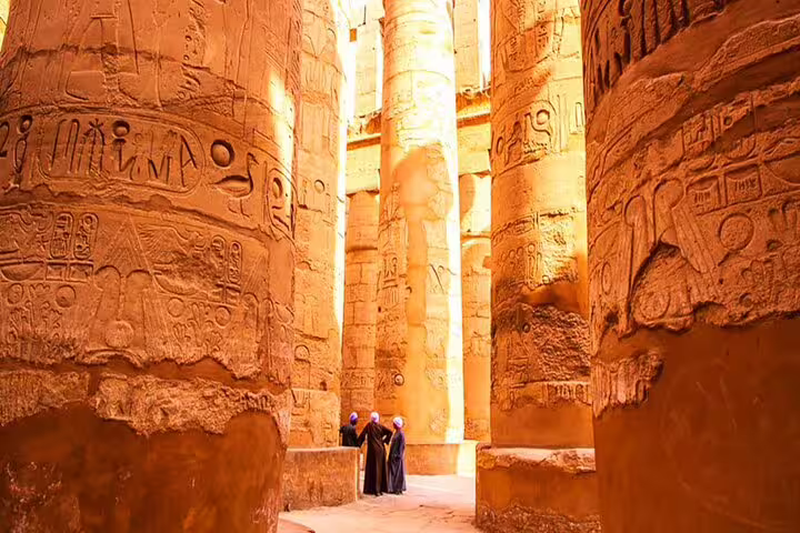 Travelers among towering Karnak Temple columns in Luxor, a highlight of the 2 day trip from Safaga port