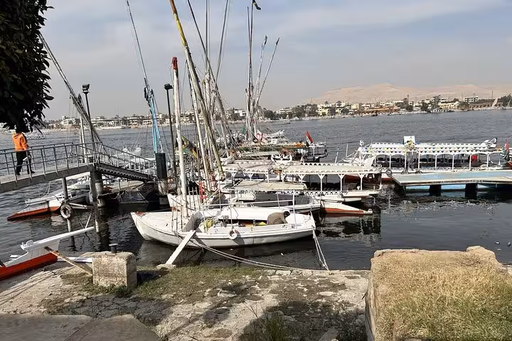 Nile River boats at Luxor dock, scenic stop on Hurghada to Luxor highlights tour with King Tut tomb visit