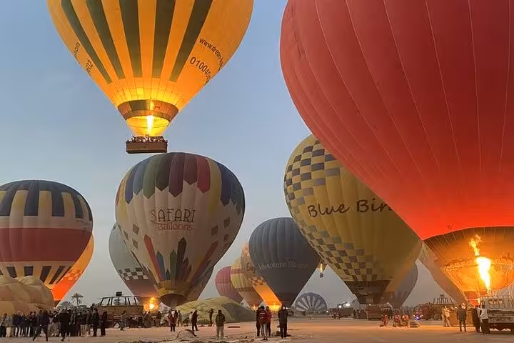 Colorful hot air balloons inflating at sunrise in Luxor for Nile River Valley hot air balloon tour