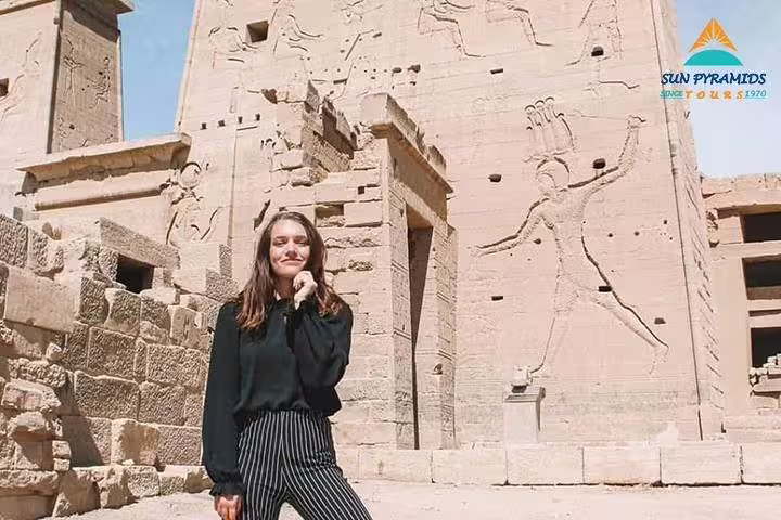 Traveler at Luxor temple wall carvings on a private day tour from Hurghada by car, Egypt culture trip