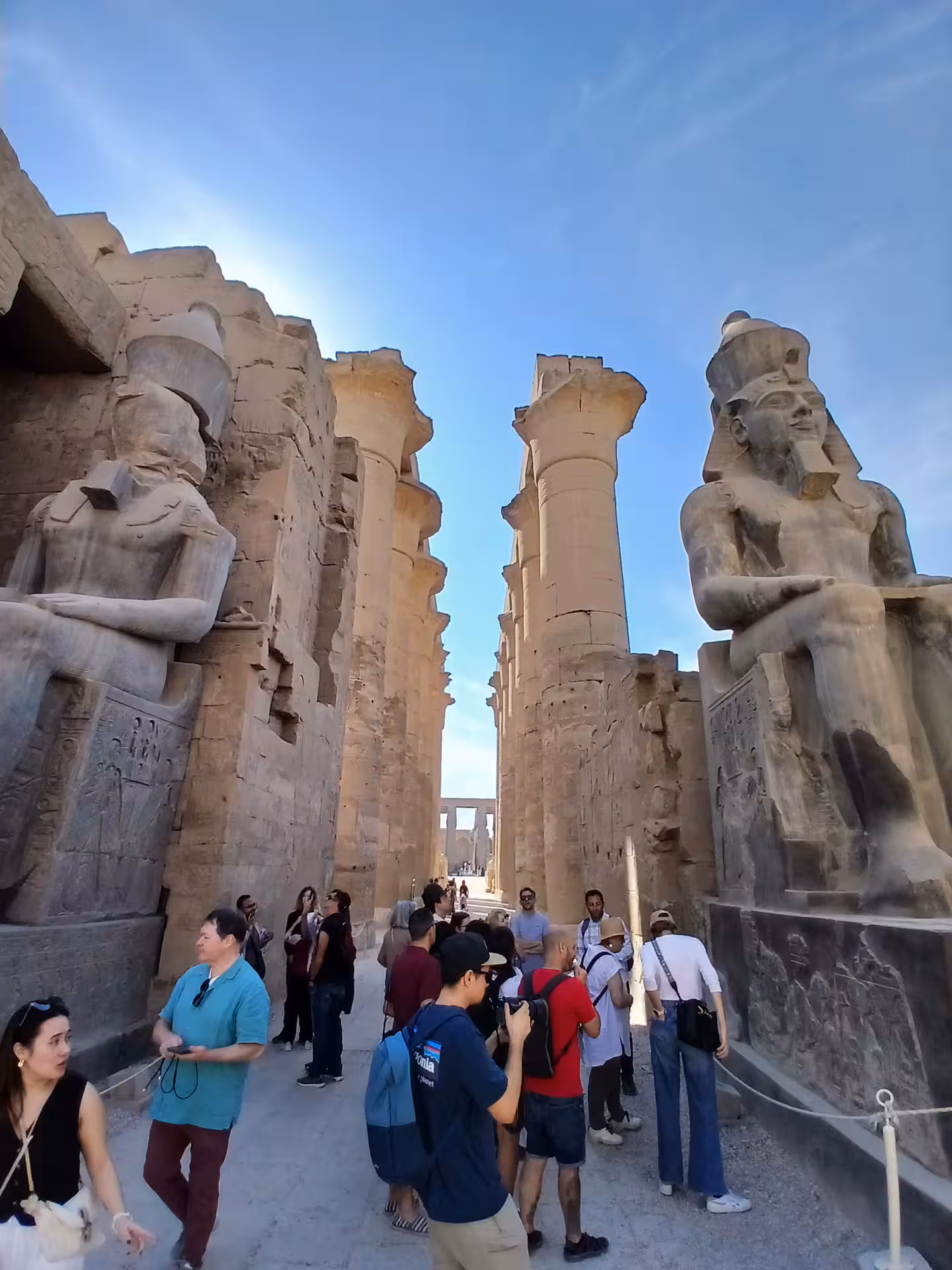 Visitors admiring colossal statues at Luxor Temple, a highlight of the Luxor & Aswan multi-day tour in Egypt.
