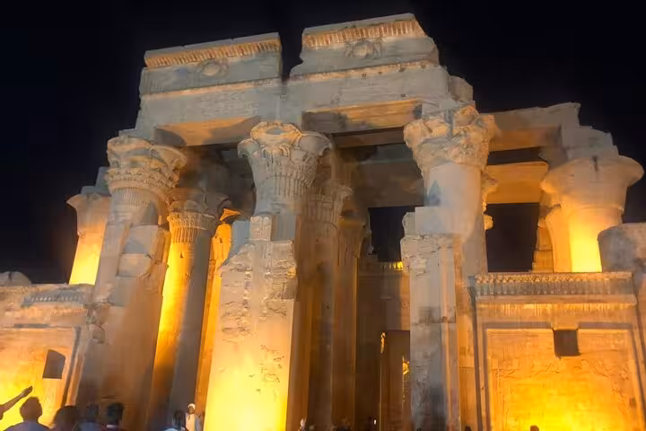 Night view of Luxor Temple columns lit in gold, a highlight of a private guided Luxor East and West Bank tour