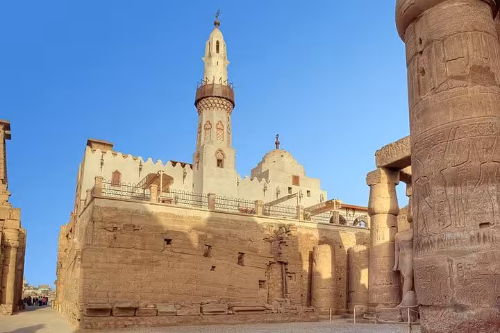 Luxor Temple ruins with mosque minaret at sunset, visited on Buy Dahabiya Nile Cruises 5 days 4 nights tour
