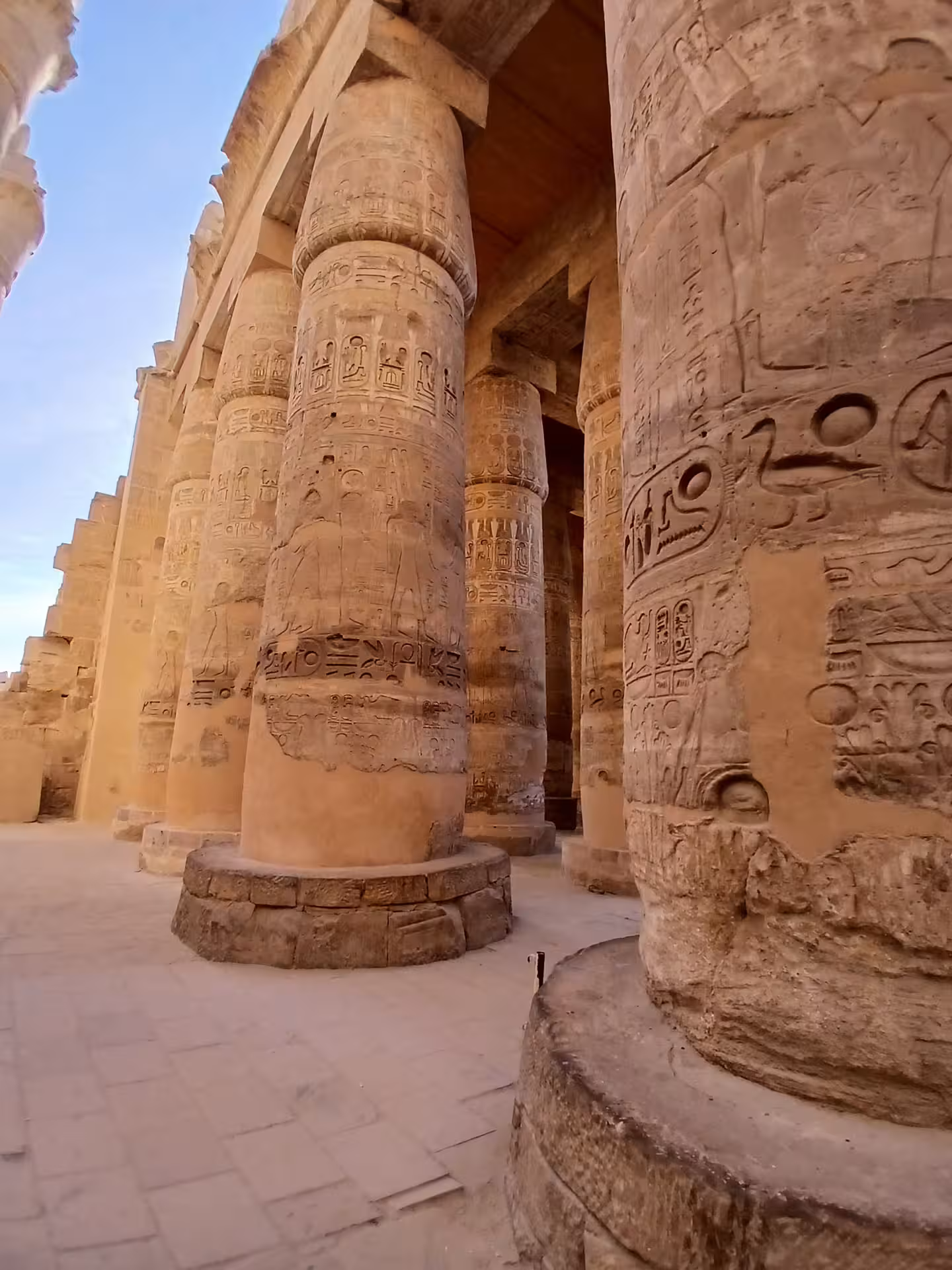 Intricately carved hieroglyphic columns at Luxor temple, showcasing ancient Egyptian architecture and history.