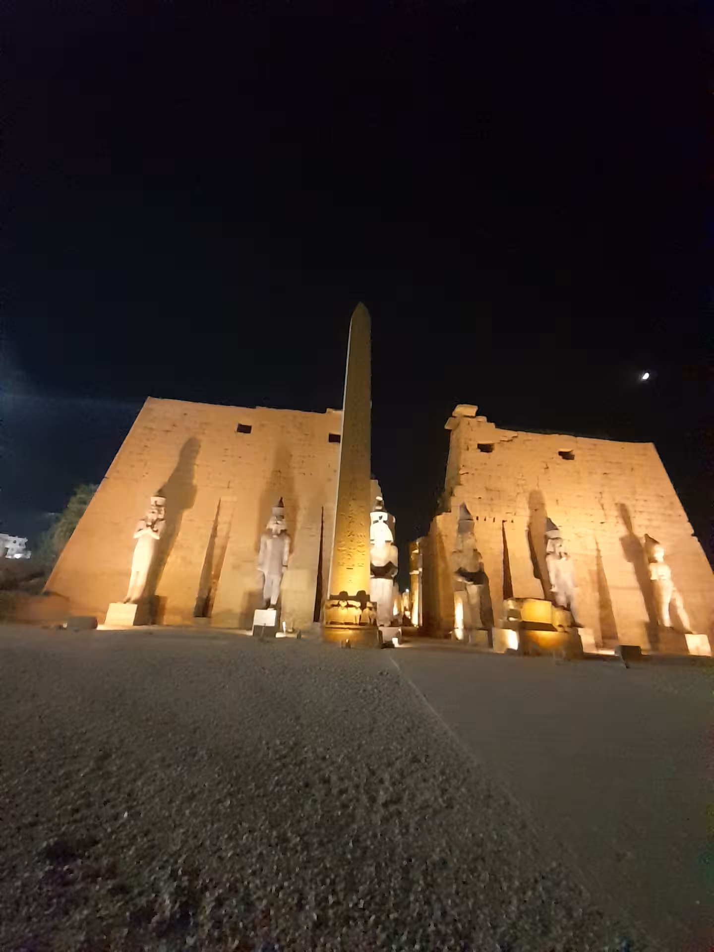 Night view of Luxor Temple's illuminated obelisk and statues, highlighting Egypt's rich archaeological heritage.