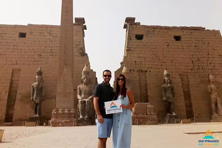 Travelers at Luxor Temple with colossal statues on an 8-day Nile cruise and Cairo tour in Egypt