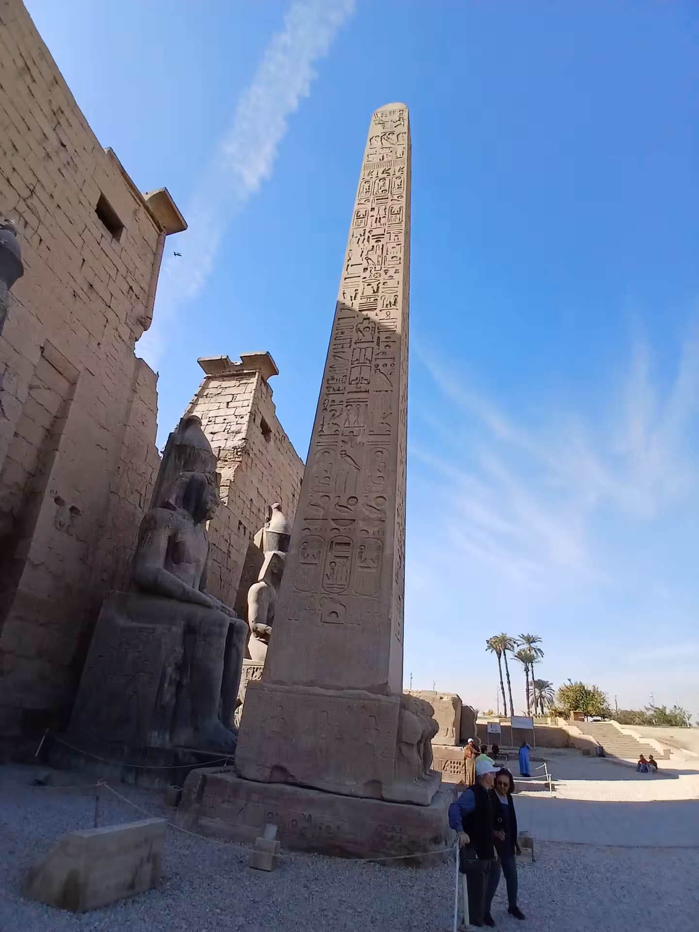 Tall obelisk with hieroglyphs at Luxor temple entrance, iconic landmark on Egypt's cultural heritage tours.