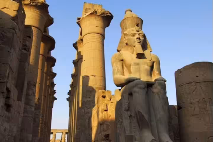 Colossal pharaoh statue and towering columns at Luxor Temple, Egypt on 9-day Cairo and Nile cruise tour