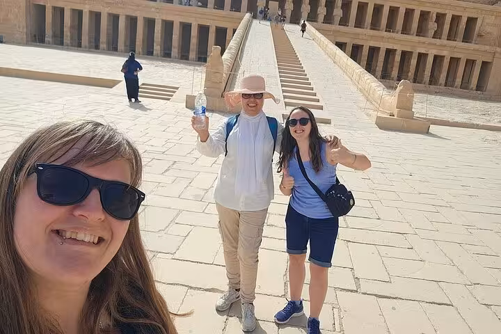 Tourists enjoying a sunny day at the entrance of Luxor Temple during a private guided tour in Egypt.
