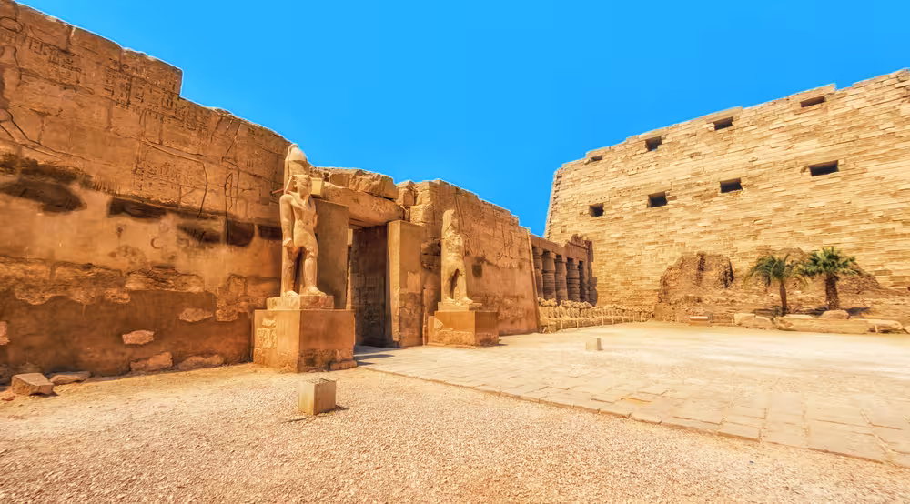 Ancient Luxor temple statues and sandstone walls, Egypt Nile cruise itinerary from Cairo to Abu Simbel