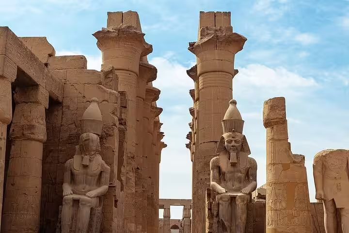 Colossal seated statues and pillars at Luxor Temple complex, visited on Sharm El Sheikh to Luxor flight tour