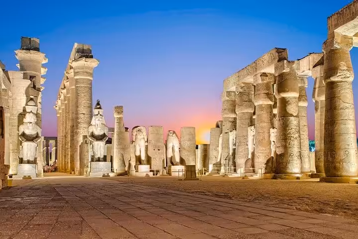 Sunset view of Luxor Temple and statues, part of a private full-day Luxor and Valley of the Kings trip from Hurghada