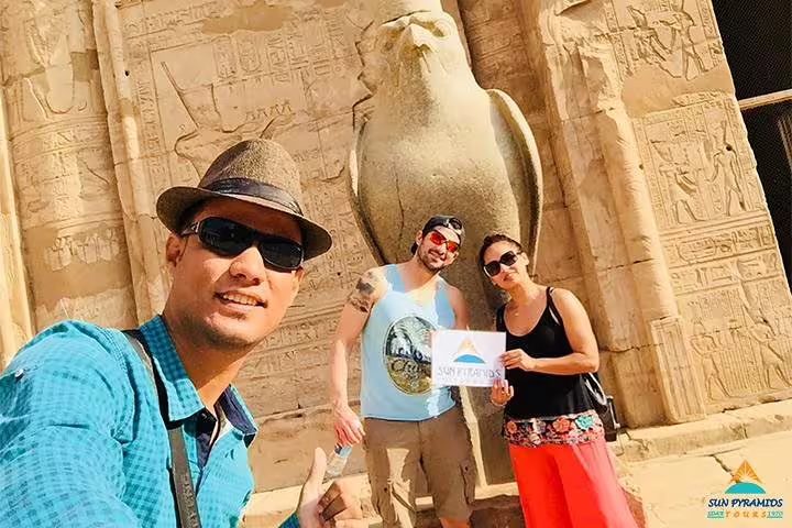 Tourists selfie at Luxor temple with ancient Egyptian reliefs on 8 days 7 nights Egypt Luxor Aswan tour