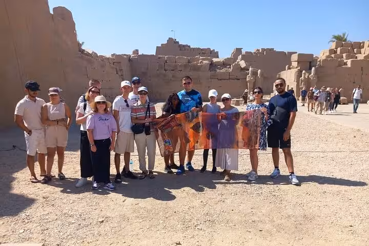 Group photo at Luxor Temple ruins on Sharm El Sheikh to Luxor flight tour, including Tutankhamun tomb visit