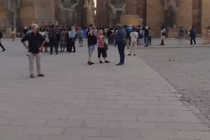 Crowds exploring Luxor temple courtyard on VIP full-day tour from Hurghada, part of hot air balloon package