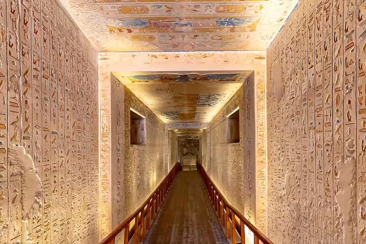 Hieroglyph-lined passage inside a Luxor tomb, part of a private day trip from Cairo by plane with guided entry