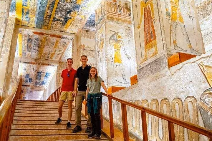 Travelers on stairway in a decorated Luxor tomb, VIP private day tour from Marsa Alam with expert guide