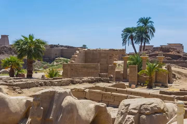 Ancient Luxor temple ruins and palm trees on Hurghada to Luxor highlights tour including King Tut tomb and lunch