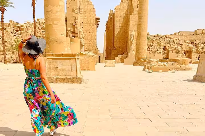 Tourist exploring Luxor Temple ruins on a private full-day excursion from Hurghada to Valley of the Kings