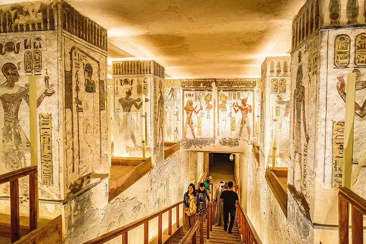 Tourists descending into decorated royal tomb, Luxor Valley of the Kings bus excursion from Hurghada Egypt