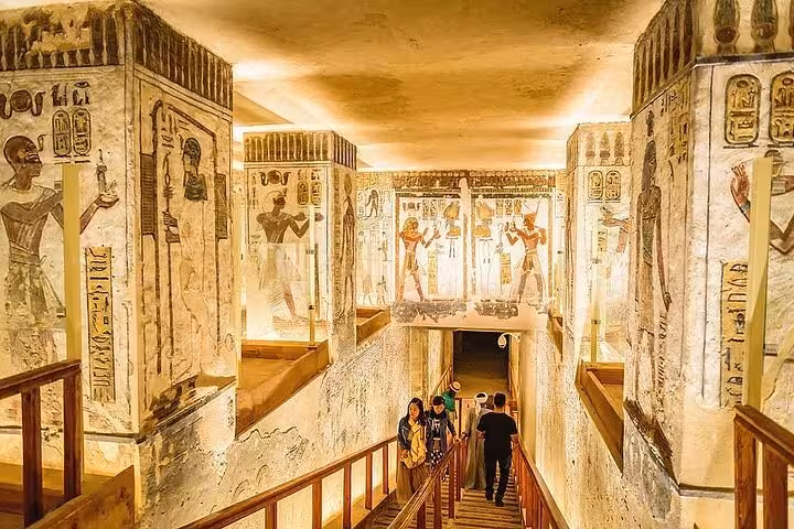 Visitors in a decorated Valley of the Kings tomb corridor in Luxor, part of a private West Bank guided tour