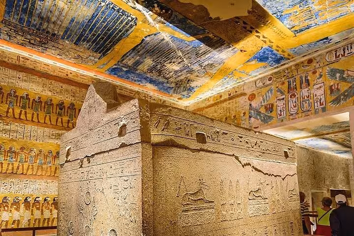Ancient sarcophagus beneath vivid tomb ceiling art in Luxor Valley of the Kings on a private West Bank tour