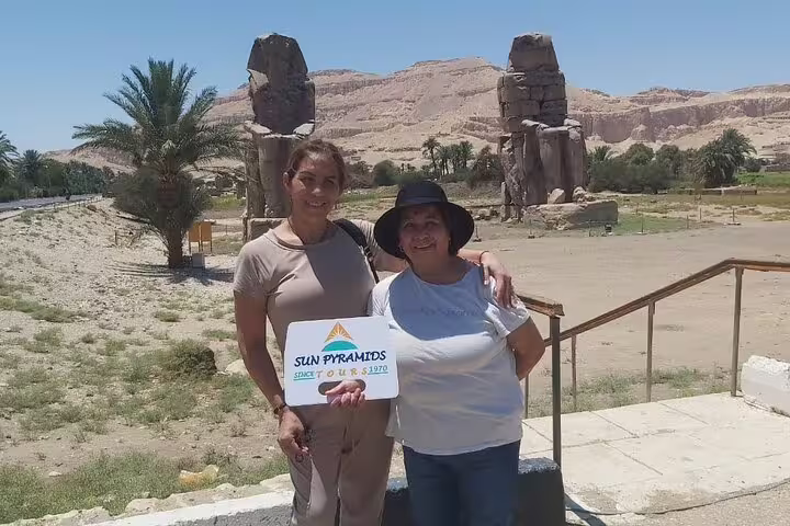 Tour guests by Colossi of Memnon on Luxor West Bank, Nile day trip to Karnak and Hatshepsut