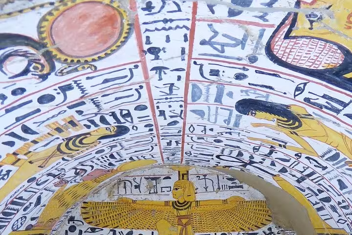 Colorful ancient Egyptian hieroglyphs and celestial art adorn the ceiling of a tomb in Luxor's West Bank.