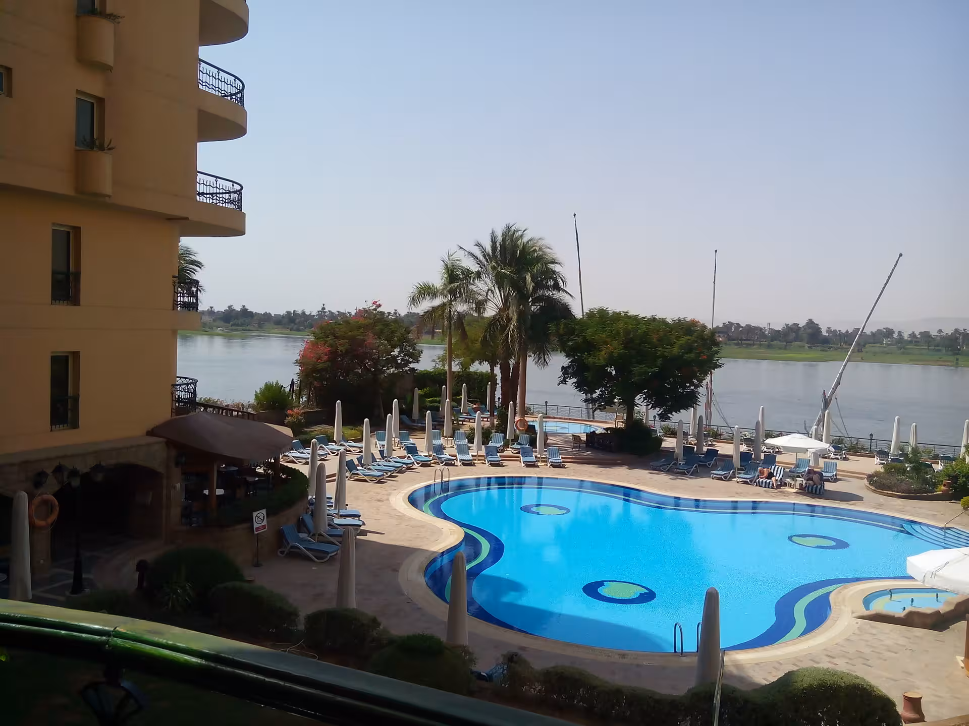 Luxurious riverside hotel in Egypt with a stunning pool overlooking the Nile, perfect for relaxing vacations.