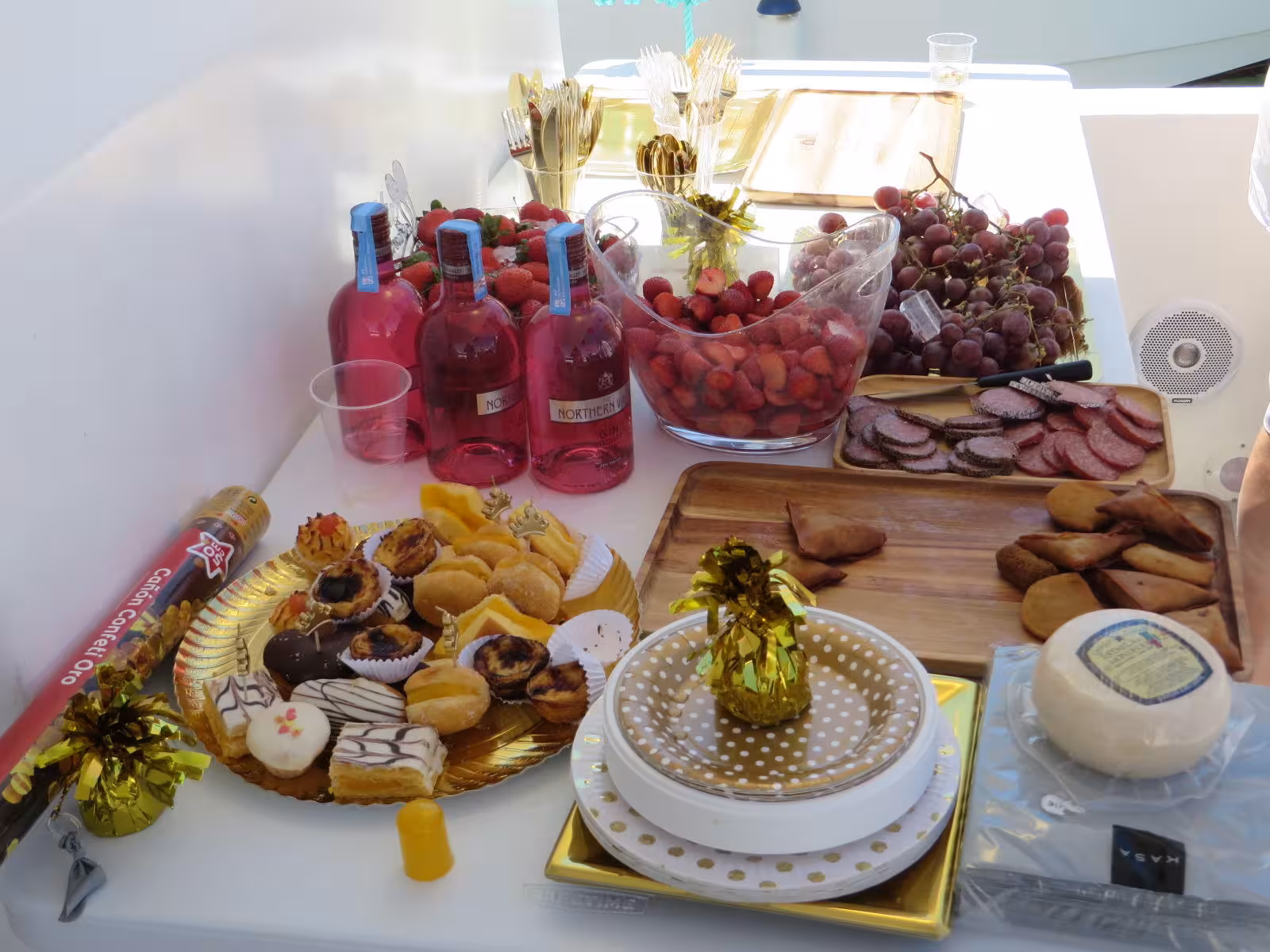 Gourmet snacks, fruit, cheese and rosé wine served on board as part of a luxury private Algarve kayak and boat tour