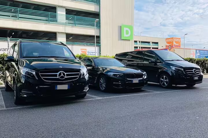 Three luxury black vehicles parked at Oslo Airport for private transfer service to Trysil Ski Resort Norway