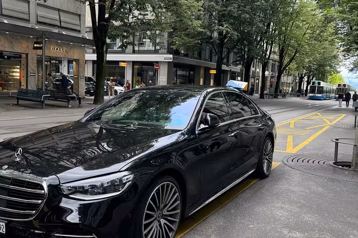 Luxury black sedan chauffeur pickup in Zurich city, reliable Zurich Airport transfer and hotel drop-off