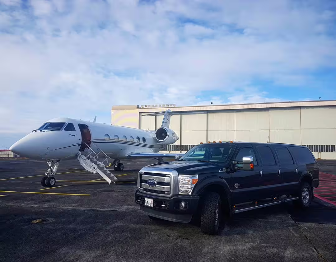 Luxury black SUV parked beside a private jet on tarmac, perfect for a tailored full-day private SUV tour experience