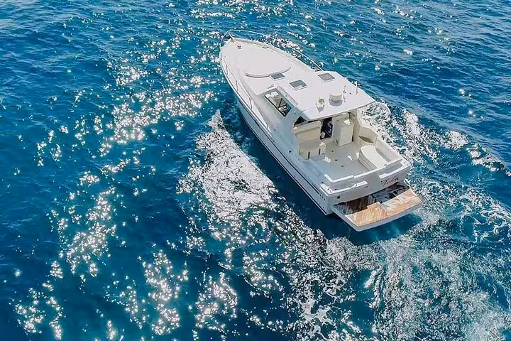 Aerial view of a luxury boat cruising the sparkling waters on an Amalfi and Positano tour from Sorrento.