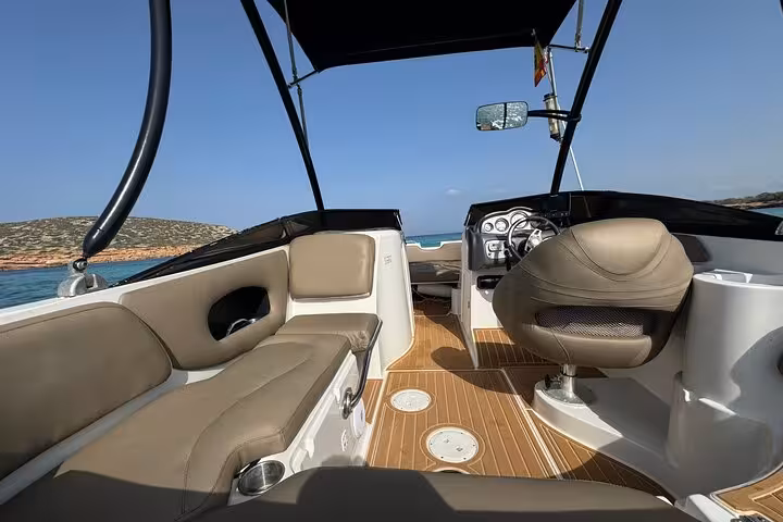 Luxurious boat interior with comfortable seating, perfect for exploring Cala Bassa and Cala Comte's hidden gems.