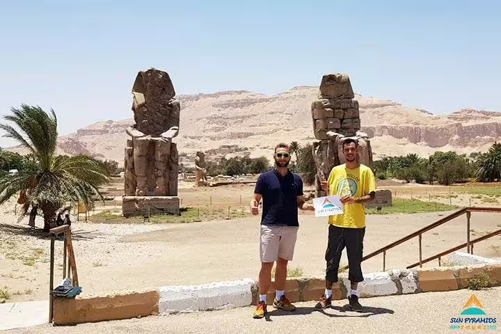 Travelers at the Colossi of Memnon in Luxor, part of Luxury 8 days Cairo tour with Oberoi Philae Nile Cruise