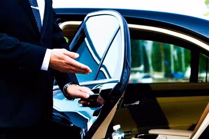 Professional driver opening luxury car door for private transfer from Sharm El Sheikh to Cairo, Egypt